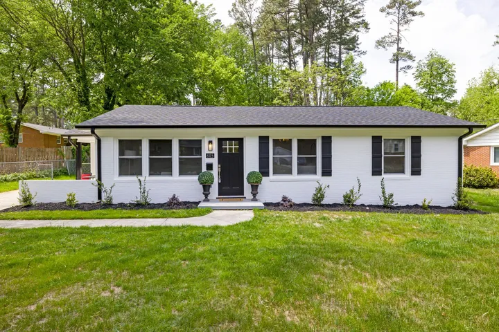 Single-story white brick home